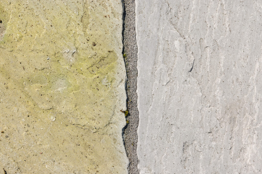 Extreme close-up of stone masonry joints and surface texture, representing the technical material assessment process by Flawless Facade.